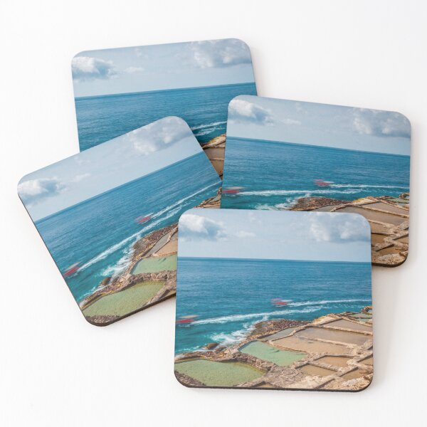 Item preview, Coastal Salt Pans Along Turquoise Sea With Boats and Rocky Cliffs Under Cloudy Sky designed and sold by Nmallia.