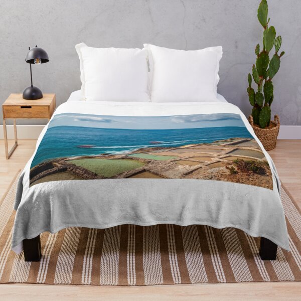 Item preview, Coastal Salt Pans Along Turquoise Sea With Boats and Rocky Cliffs Under Cloudy Sky designed and sold by Nmallia.