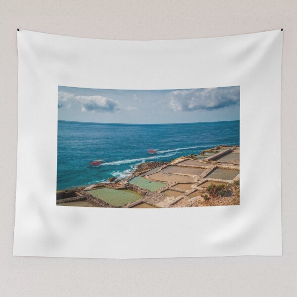 Item preview, Coastal Salt Pans Along Turquoise Sea With Boats and Rocky Cliffs Under Cloudy Sky designed and sold by Nmallia.