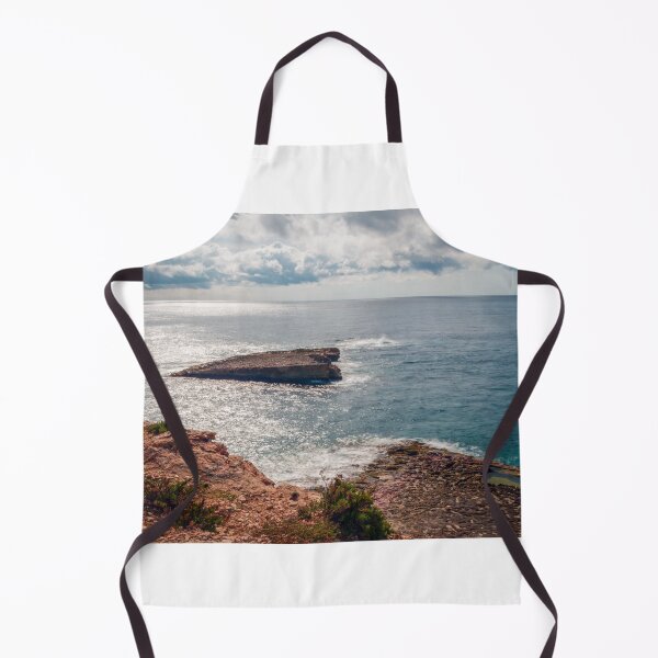 Item preview, Sunlit Rocky Coastline and Small Island Under Cloudy Sky With Calm Blue Sea and Sparkling Horizon designed and sold by Nmallia.