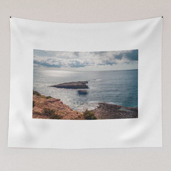 Item preview, Sunlit Rocky Coastline and Small Offshore Island With Calm Ocean Under Cloudy Sky designed and sold by Nmallia.