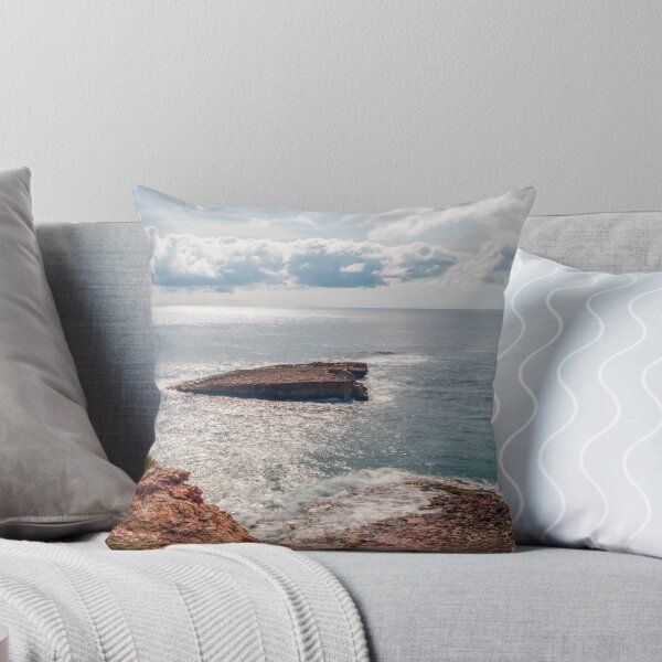 Item preview, Sunlit Rocky Coastline and Small Offshore Island Under Cloudy Sky Over Calm Blue Ocean designed and sold by Nmallia.
