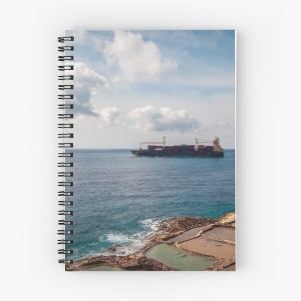 Item preview, Container Ship Passing Offshore Above Coastal Salt Pans Under Blue Sky And Clouds designed and sold by Nmallia.
