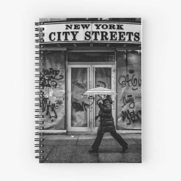 Item preview, New York city streets, woman with an umbrella next to a dilapidated storefront black and white vintage photograph poster art print designed and sold by Astrid Arkhangelsky.