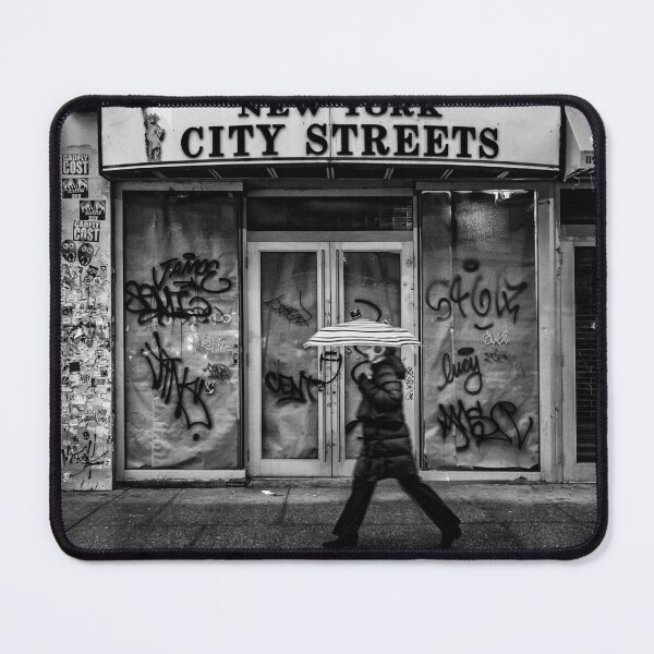 Item preview, New York city streets, woman with an umbrella next to a dilapidated storefront black and white vintage photograph poster art print designed and sold by Astrid Arkhangelsky.