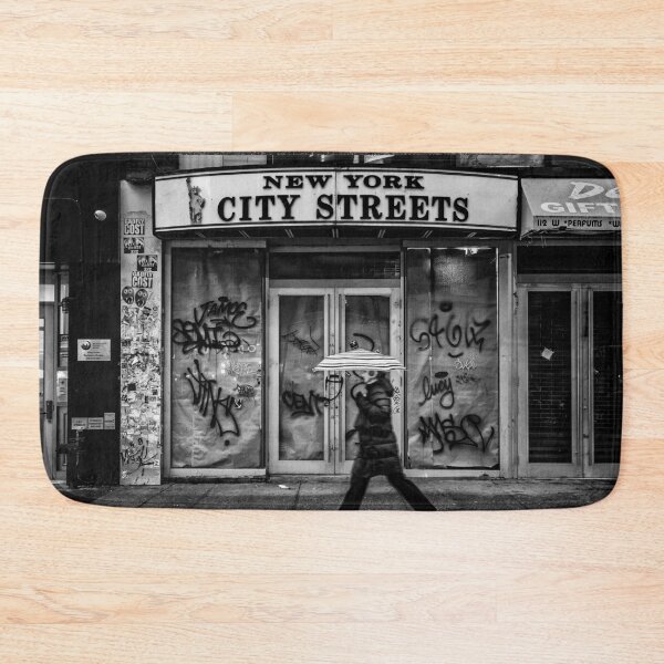 Item preview, New York city streets, woman with an umbrella next to a dilapidated storefront black and white vintage photograph poster art print designed and sold by Astrid Arkhangelsky.