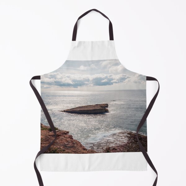 Item preview, Sunlit Rocky Coastline With Small Sea Stack and Calm Ocean Under a Cloudy Sky designed and sold by Nmallia.