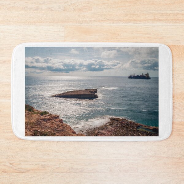 Item preview, Rocky Coastline Overlooking Calm Sea With Cargo Ship on Horizon and Sunlit Waves designed and sold by Nmallia.
