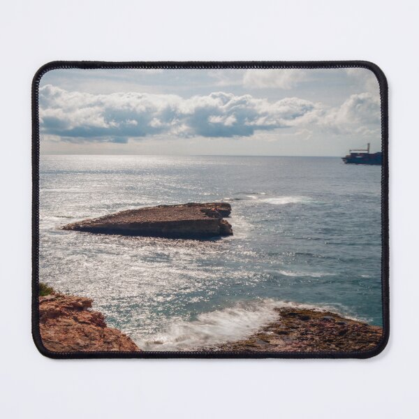 Item preview, Rocky Coastline Overlooking Calm Sea With Cargo Ship on Horizon and Sunlit Waves designed and sold by Nmallia.