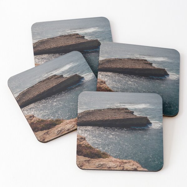 Item preview, Sunlit Rocky Cliff Overlooking Calm Blue Ocean With Flat Sea Stack And Sparkling Water designed and sold by Nmallia.