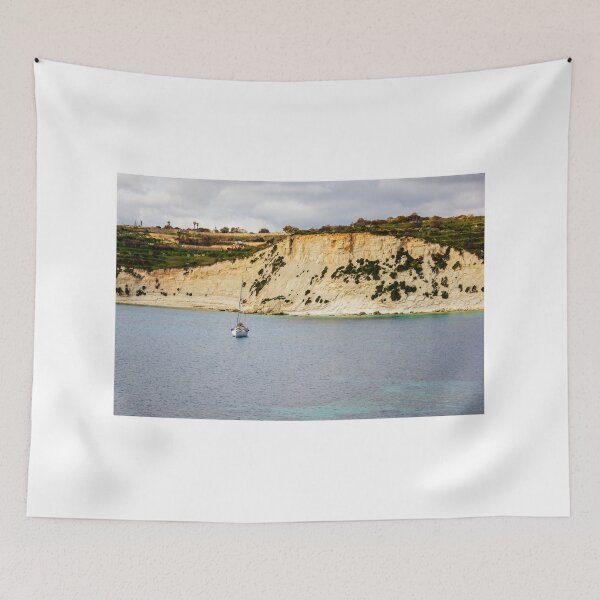 Item preview, Sailboat Anchored Off Rugged Coastal Cliff With Turquoise Sea and Scenic Rocky Shoreline designed and sold by Nmallia.