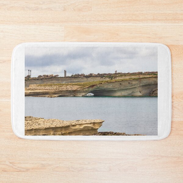 Item preview, Boat Passing Through Natural Coastal Arch Beneath Layered Limestone Cliffs On Calm Sea Under Cloudy Sky designed and sold by Nmallia.