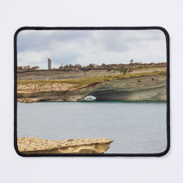 Item preview, Boat Passing Through Natural Coastal Arch Beneath Layered Limestone Cliffs On Calm Sea Under Cloudy Sky designed and sold by Nmallia.
