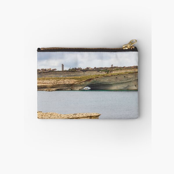 Item preview, Boat Passing Through Natural Coastal Arch Beneath Layered Limestone Cliffs On Calm Sea Under Cloudy Sky designed and sold by Nmallia.
