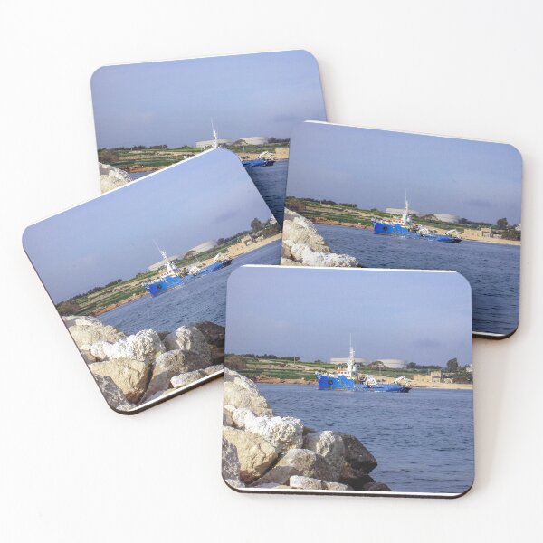 Item preview, Blue Work Boat Near Rocky Coastline With Harbor Buildings and Industrial Tanks Under Blue Sky designed and sold by Nmallia.