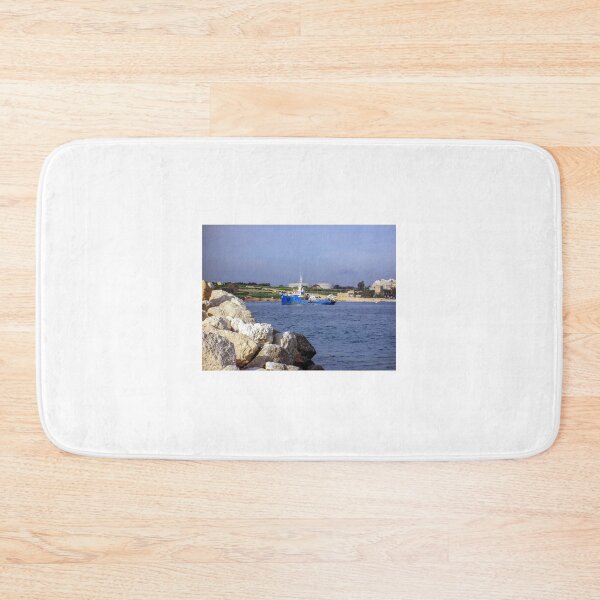 Item preview, Blue Work Boat Near Rocky Coastline With Harbor Buildings and Industrial Tanks Under Blue Sky designed and sold by Nmallia.