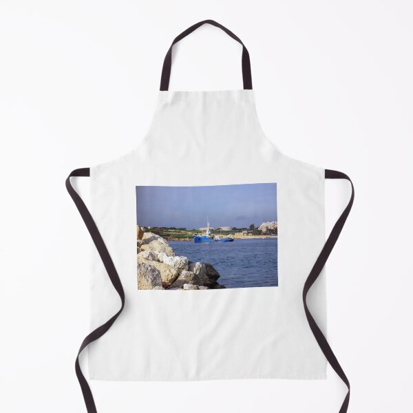 Item preview, Blue Work Boat Near Rocky Coastline With Harbor Buildings and Industrial Tanks Under Blue Sky designed and sold by Nmallia.