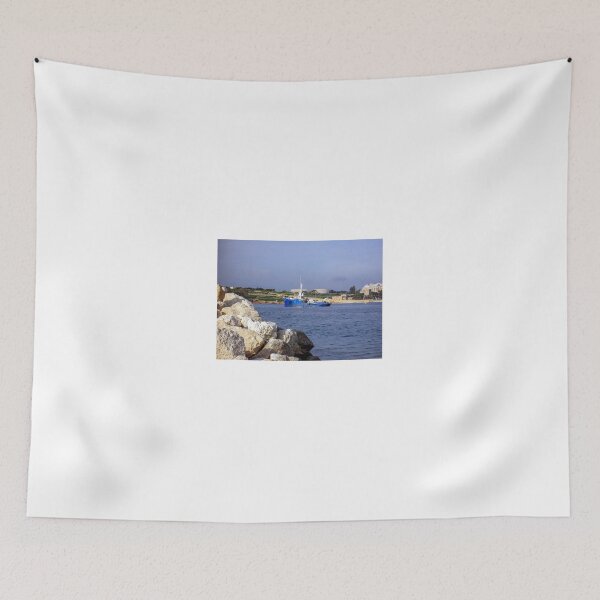 Item preview, Blue Work Boat Near Rocky Coastline With Harbor Buildings and Industrial Tanks Under Blue Sky designed and sold by Nmallia.