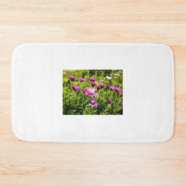 Item preview, Purple Daisies Blooming in Sunny Green Garden Bed With Vibrant Spring Flowers designed and sold by Nmallia.