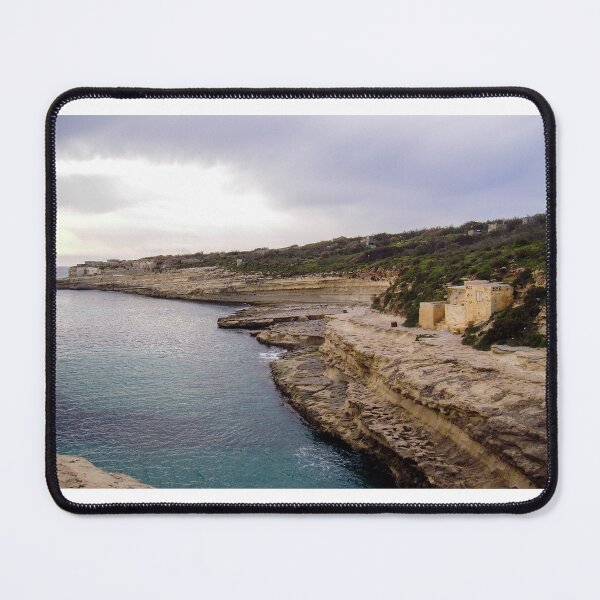 Item preview, Rocky Cliff Coastline Over Calm Sea With Old Stone Buildings And Overcast Sky designed and sold by Nmallia.