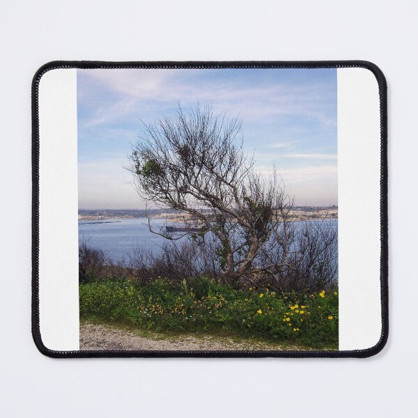 Item preview, Windswept Tree On Coastal Bluff Overlooking Calm Blue Sea With Wildflowers In Foreground designed and sold by Nmallia.
