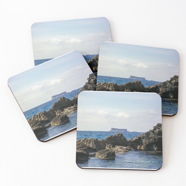Item preview, Rocky Coastline and Distant Flat‑Topped Island on a Calm Blue Sea at Horizon designed and sold by Nmallia.