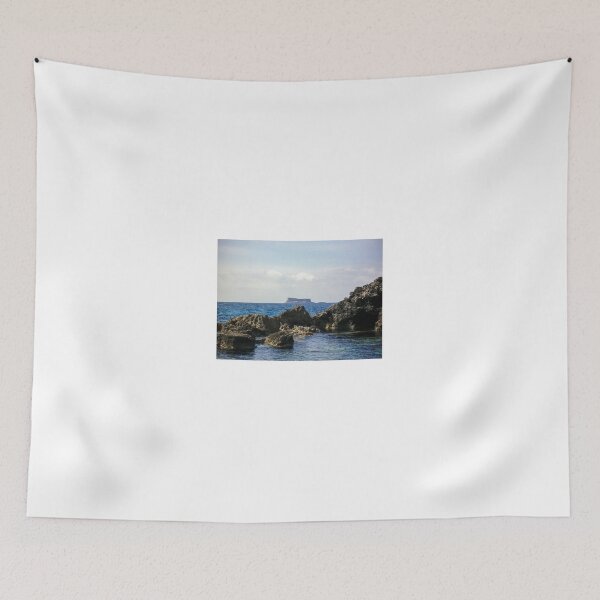 Item preview, Rocky Coastline and Distant Flat‑Topped Island on a Calm Blue Sea at Horizon designed and sold by Nmallia.