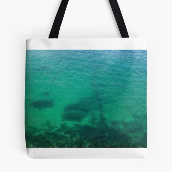 Item preview, Aerial View of Turquoise Ocean Water and Rocky Reef Shadows Over Shallow Sea designed and sold by Nmallia.