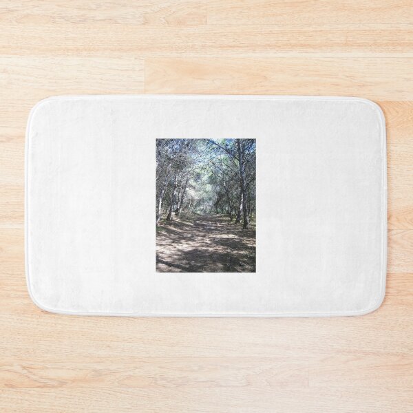 Item preview, Sunlit Forest Path Through Pine Trees Along a Quiet Woodland Trail With Dappled Shadows designed and sold by Nmallia.