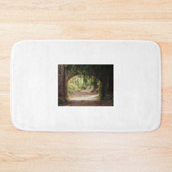 Item preview, Stone Archway Framing a Sunlit Forest Path Through Lush Woodland and Ancient Trees designed and sold by Nmallia.