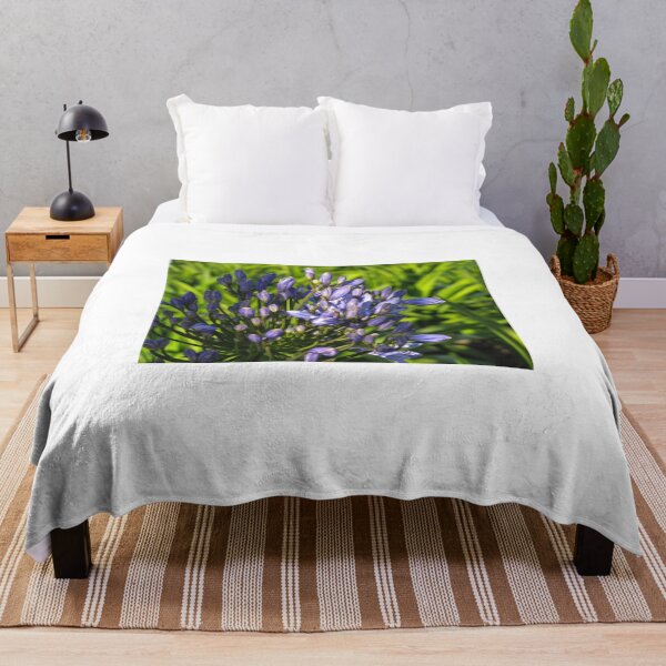 Item preview, Purple Agapanthus Buds And Blooms Close-Up In Sunny Garden With Green Leaves Background designed and sold by Nmallia.