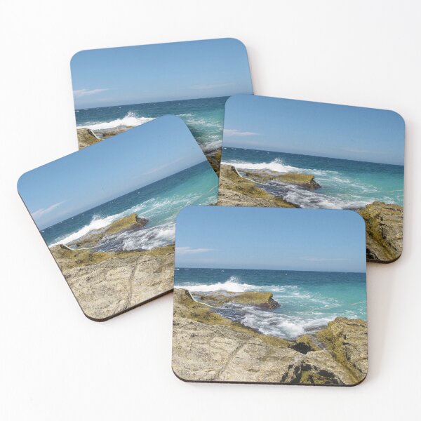 Item preview, Rocky Shoreline With Turquoise Ocean Waves Crashing Against Coastal Rocks Under Clear Blue Sky designed and sold by Nmallia.
