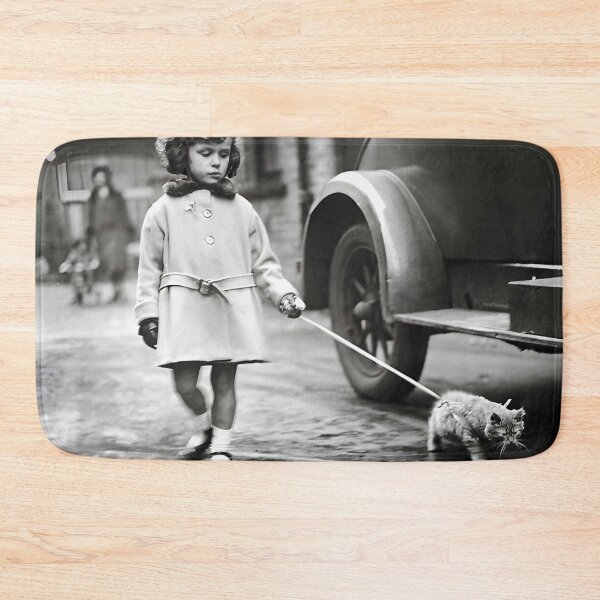 Item preview, Vintage little girl walking her kitten on a lash funny cute black and white photograph poster art print designed and sold by Astrid Arkhangelsky.
