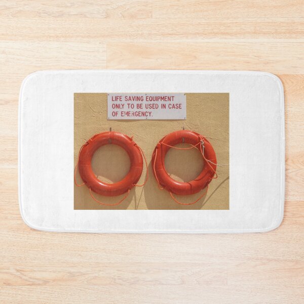 Item preview, Two Orange Lifebuoys Mounted Under Life Saving Equipment Emergency Sign On Wall designed and sold by Nmallia.