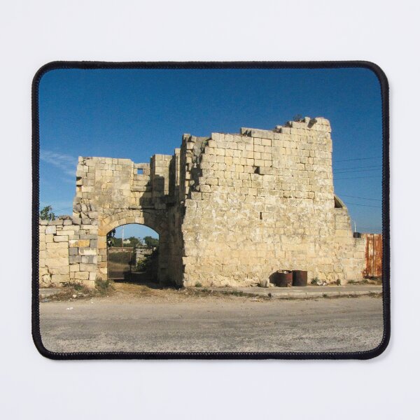 Item preview, Old Stone Ruins With Archway and Rusted Gate Beside Road Under Blue Sky designed and sold by Nmallia.