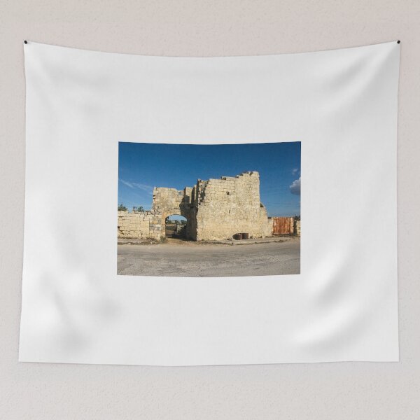 Item preview, Old Stone Ruins With Archway and Rusted Gate Beside Road Under Blue Sky designed and sold by Nmallia.