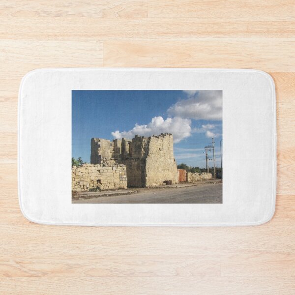 Item preview, Old Stone Ruins With Archway and Rusted Gate Beside Road Under Blue Sky designed and sold by Nmallia.