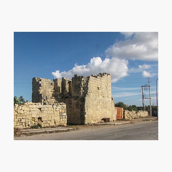 Item preview, Old Stone Ruins With Archway and Rusted Gate Beside Road Under Blue Sky designed and sold by Nmallia.