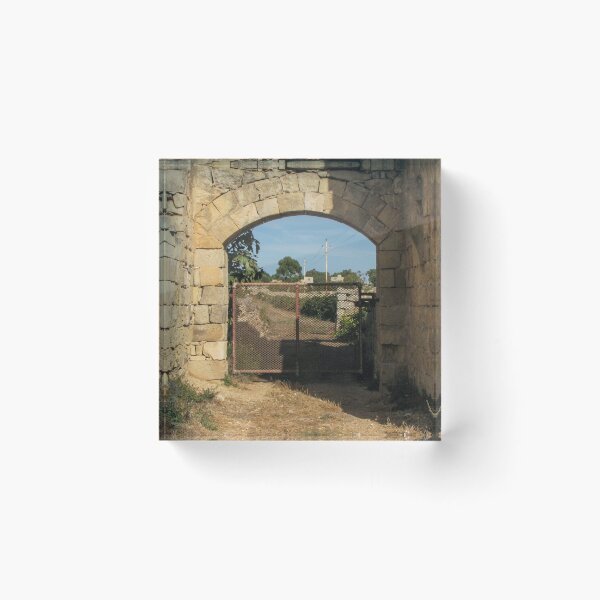 Item preview, Old Stone Archway With Rusty Metal Gate Framing a Rural Path and Sunlit Countryside designed and sold by Nmallia.