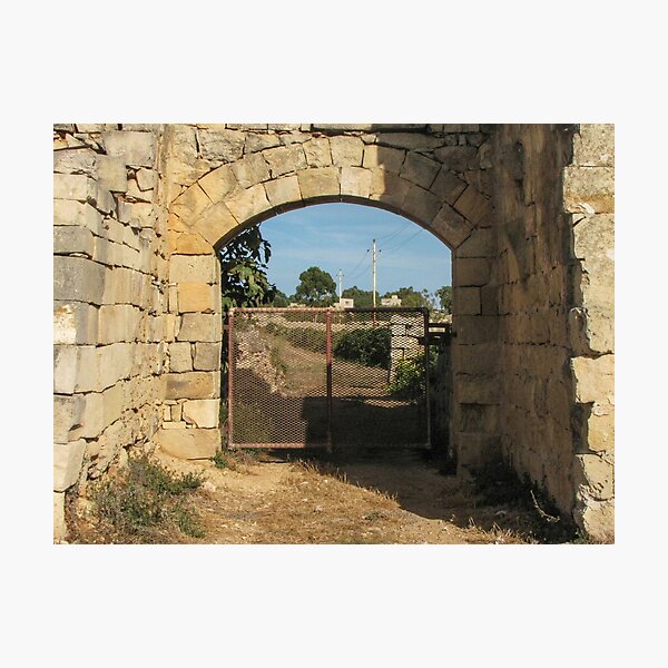 Item preview, Old Stone Archway With Rusty Metal Gate Framing a Rural Path and Sunlit Countryside designed and sold by Nmallia.