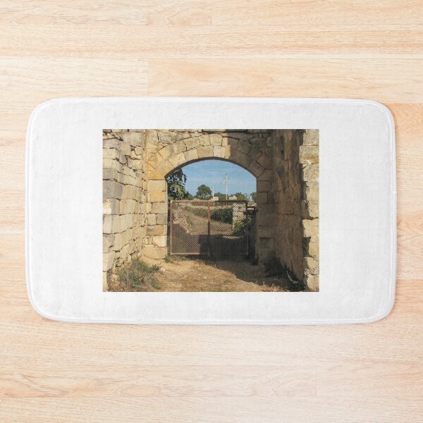 Item preview, Old Stone Archway With Rusty Metal Gate Framing a Rural Path and Sunlit Countryside designed and sold by Nmallia.