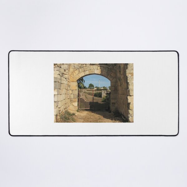 Item preview, Old Stone Archway With Rusty Metal Gate Framing a Rural Path and Sunlit Countryside designed and sold by Nmallia.