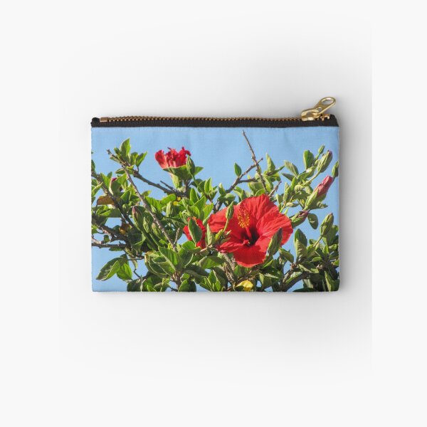 Item preview, Vibrant Red Hibiscus Blossom On Green Shrub Branches Against Clear Blue Sky Close-Up designed and sold by Nmallia.