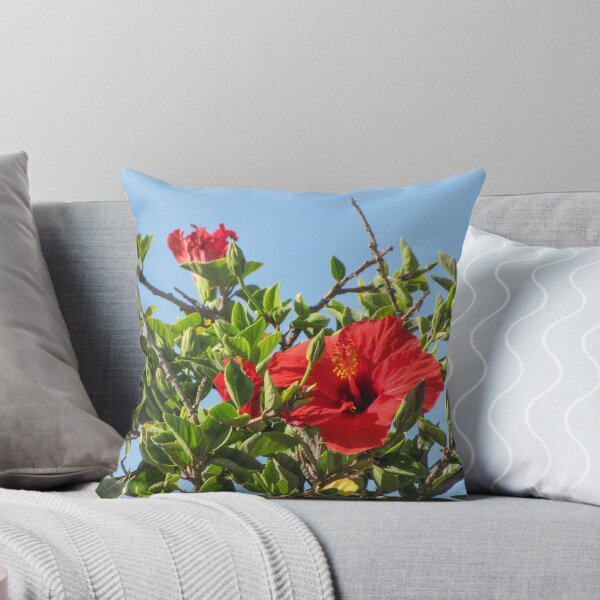 Item preview, Vibrant Red Hibiscus Blossom On Green Shrub Branches Against Clear Blue Sky Close-Up designed and sold by Nmallia.