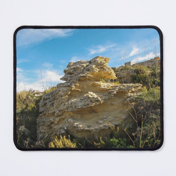 Item preview, Eroded Limestone Rock Formation in Rugged Mediterranean Landscape With Blue Sky and Coastal Vegetation designed and sold by Nmallia.