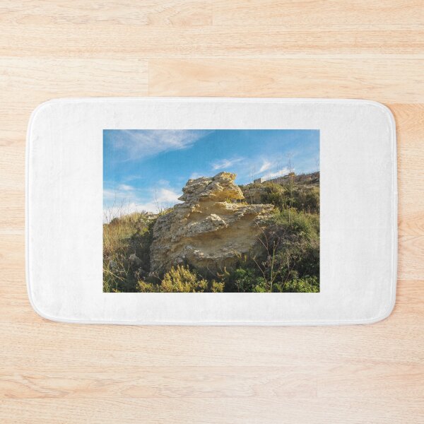 Item preview, Eroded Limestone Rock Formation in Rugged Mediterranean Landscape With Blue Sky and Coastal Vegetation designed and sold by Nmallia.