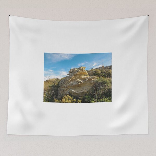 Item preview, Eroded Limestone Rock Formation in Rugged Mediterranean Landscape With Blue Sky and Coastal Vegetation designed and sold by Nmallia.