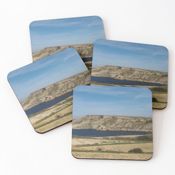 Item preview, Rocky Coastal Cliffs Overlooking A Calm Blue Bay With Farmland And Clear Sky designed and sold by Nmallia.