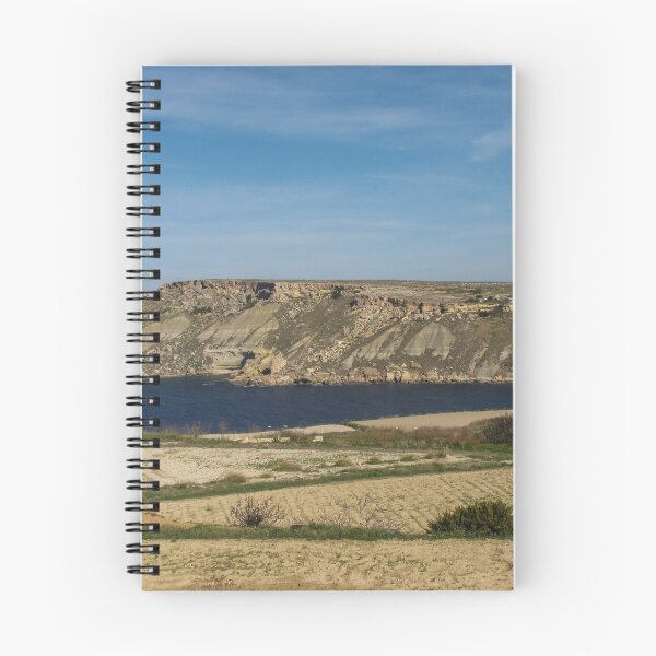 Item preview, Rocky Coastal Cliffs Overlooking A Calm Blue Bay With Farmland And Clear Sky designed and sold by Nmallia.