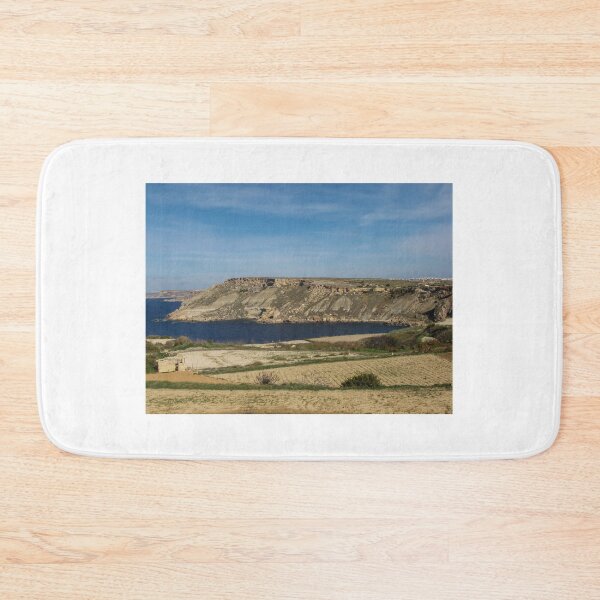 Item preview, Rocky Coastal Cliffs Overlooking A Calm Blue Bay With Farmland And Clear Sky designed and sold by Nmallia.